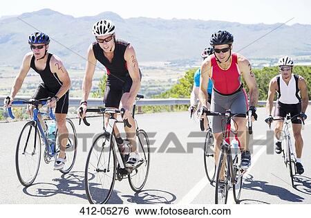 Cyclists in race on rural road View Large Photo Image Stock Photograph - Cyclists in race on rural road. Fotosearch