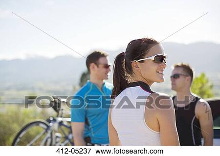 Stock Photo - Cyclists talking on rural road. Fotosearch