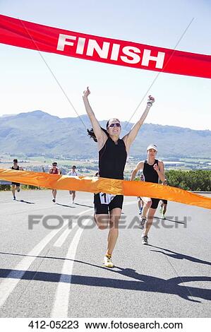 Runner crossing race finish line View Large Photo Image Stock Image - Runner crossing race finish line. Fotosearch