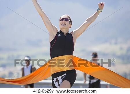 Runner crossing race finish line View Large Photo Image Stock Photo - Runner crossing race finish line. Fotosearch