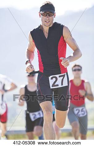 Stock Photo - Runner in race on rural road. Fotosearch