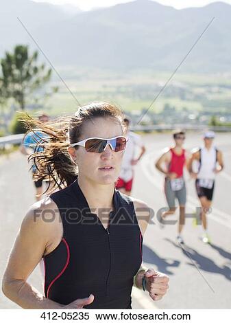 Stock Photography - Runner in race on rural road. Fotosearch
