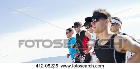 Stock Photography - Runners in race in rural landscape. Fotosearch