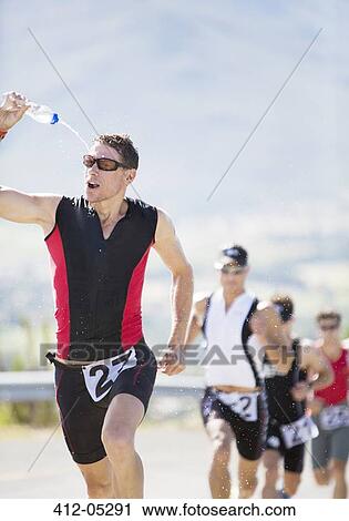 Stock Image - Runners in race on rural road. Fotosearch