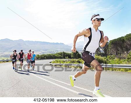Runners in race on rural road View Large Photo Image Stock Photo - Runners in race on rural road. Fotosearch