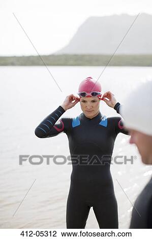 Triathlete adjusting goggles outdoors View Large Photo Image Stock Image - Triathlete adjusting goggles outdoors. Fotosearch