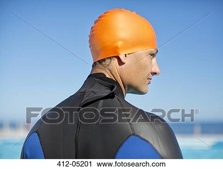 Triathlete wearing wetsuit and cap View Large Photo Image Stock Image - Triathlete wearing wetsuit and cap. Fotosearch