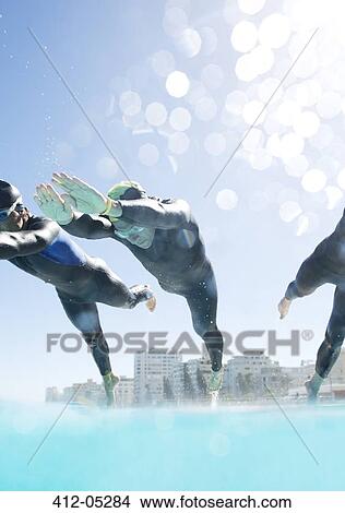 Triathletes diving into swimming pool View Large Photo Image Picture - Triathletes diving into swimming pool. Fotosearch