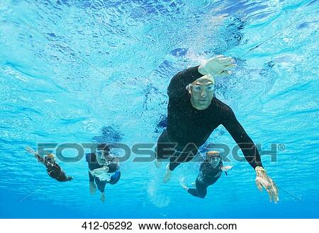 Triathletes in wetsuits underwater View Large Photo Image Stock Image - Triathletes in wetsuits underwater. Fotosearch