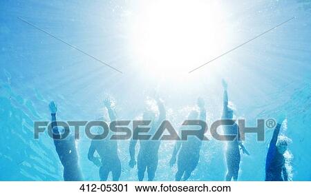 Stock Image - Triathletes in wetsuits underwater. Fotosearch