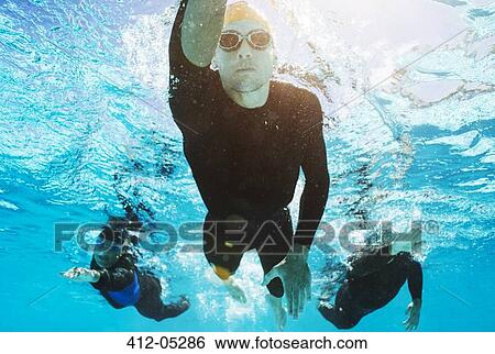 Triathletes in wetsuits underwater View Large Photo Image Stock Photograph - Triathletes in wetsuits underwater. Fotosearch