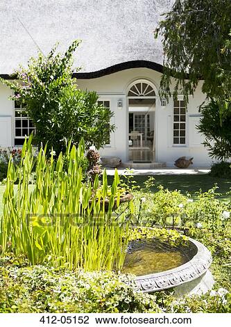 Birdbath in garden outside house View Large Photo Image Stock Image - Birdbath in garden outside house. Fotosearch