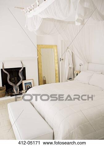 Stock Image - Canopy bed in modern bedroom. Fotosearch