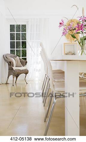 Stock Photo - Chairs at table in dining room. Fotosearch