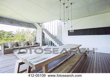 Dining table and sofa in modern house View Large Photo Image Stock Photo - Dining table and sofa in modern house. Fotosearch