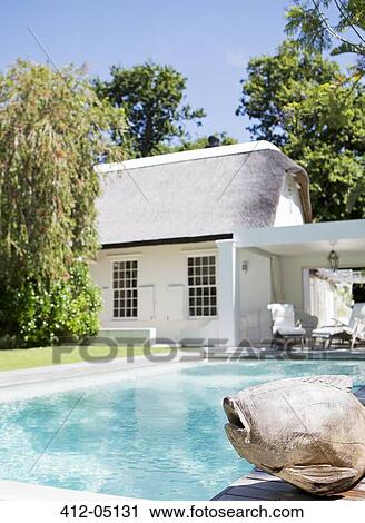 Fish sculpture by swimming pool in backyard View Large Photo Image Stock Image - Fish sculpture by swimming pool in backyard. Fotosearch