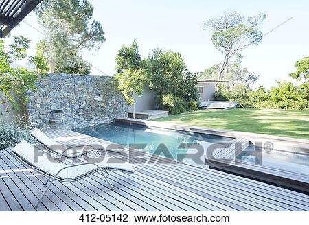 Lawn chairs and swimming pool in backyard View Large Photo Image Stock Image - Lawn chairs and swimming pool in backyard. Fotosearch