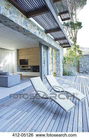 Lawn chairs on wooden patio View Large Photo Image Stock Photograph - Lawn chairs on wooden patio. Fotosearch