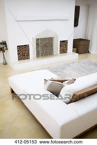Stock Image - Sofa and fireplace in modern living room. Fotosearch