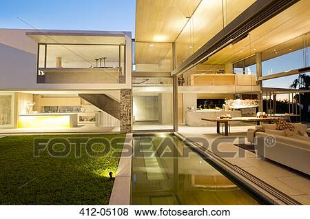 Swimming pool and patio of modern house View Large Photo Image Stock Photo - Swimming pool and patio of modern house. Fotosearch