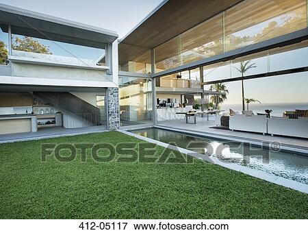 Swimming pool and patio of modern house View Large Photo Image Stock Photo - Swimming pool and patio of modern house. Fotosearch