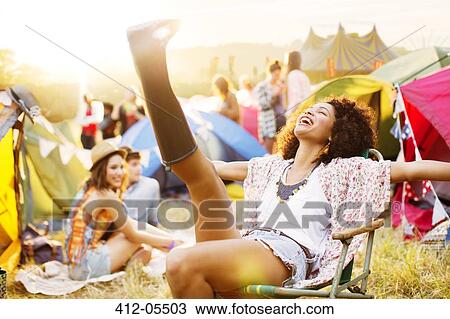 Carefree woman outside tents at music festival View Large Photo Image Stock Image - Carefree woman outside tents at music festival. Fotosearch