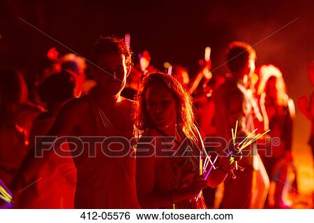 Couple dancing at music festival View Large Photo Image Stock Photograph - Couple dancing at music festival. Fotosearch