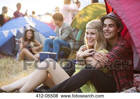 Couple hugging outside tent at music festival View Large Photo Image Stock Photo - Couple hugging outside tent at music festival. Fotosearch