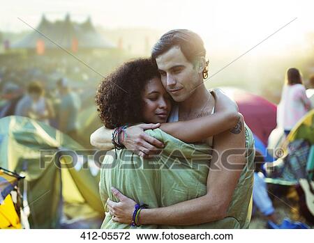 Couple in sleeping bag hugging outside tents at music festival View Large Photo Image Stock Image - Couple in sleeping bag hugging outside tents at music festival. Fotosearch