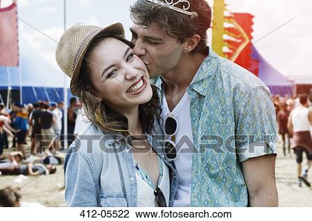 Couple kissing at music festival View Large Photo Image Stock Image - Couple kissing at music festival. Fotosearch