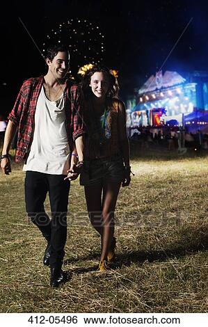 Stock Photograph - Couple leaving music festival. Fotosearch