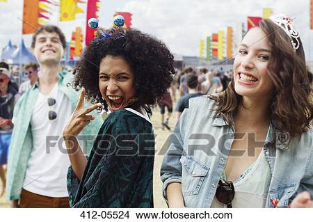 Picture - Enthusiastic friends at music festival. Fotosearch