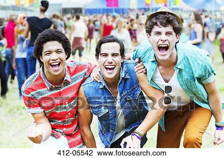 Stock Image - Enthusiastic men cheering at music festival. Fotosearch