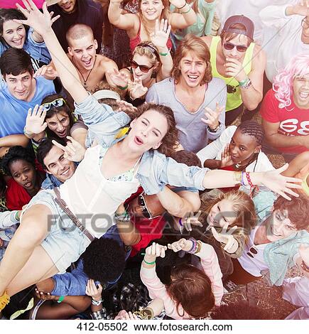Enthusiastic woman crowd surfing at music festival View Large Photo Image Stock Image - Enthusiastic woman crowd surfing at music festival. Fotosearch