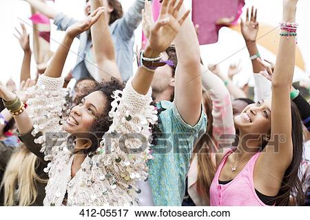Fans cheering at music festival View Large Photo Image Stock Photo - Fans cheering at music festival. Fotosearch