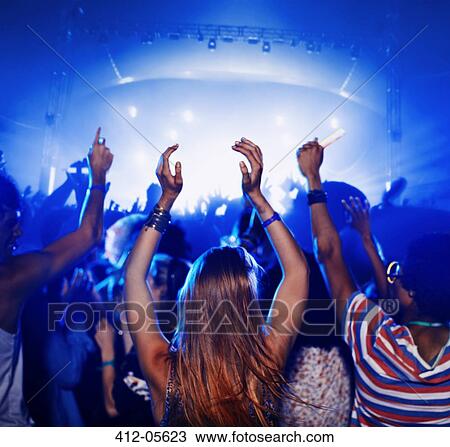 Fans dancing and cheering at music festival View Large Photo Image Stock Image - Fans dancing and cheering at music festival. Fotosearch