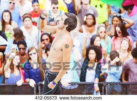 Fans watching performer sing at music festival View Large Photo Image Stock Image - Fans watching performer sing at music festival. Fotosearch