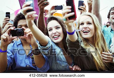 Fans with cameras and camera phones at music festival View Large Photo Image Stock Photo - Fans with cameras and camera phones at music festival. Fotosearch