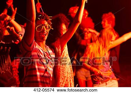 Friends dancing at music festival View Large Photo Image Picture - Friends dancing at music festival. Fotosearch