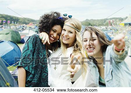 Friends hugging outside tents at music festival View Large Photo Image Picture - Friends hugging outside tents at music festival. Fotosearch