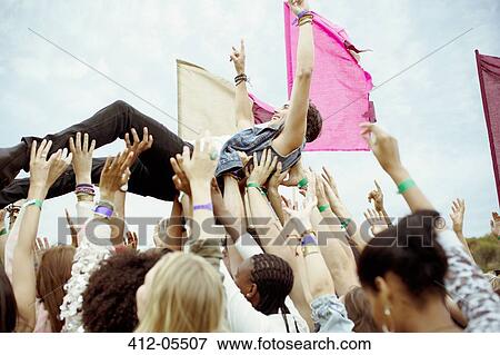 Man crowd surfing at music festival View Large Photo Image Stock Photo - Man crowd surfing at music festival. Fotosearch