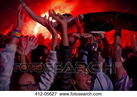 Man crowd surfing at music festival View Large Photo Image Stock Photo - Man crowd surfing at music festival. Fotosearch