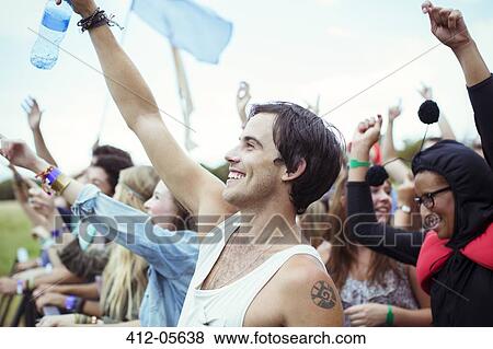 Man with water bottle cheering at music festival View Large Photo Image Stock Photo - Man with water bottle cheering at music festival. Fotosearch