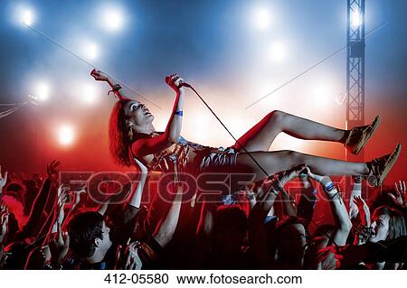 Performer crowd surfing at music festival View Large Photo Image Stock Image - Performer crowd surfing at music festival. Fotosearch