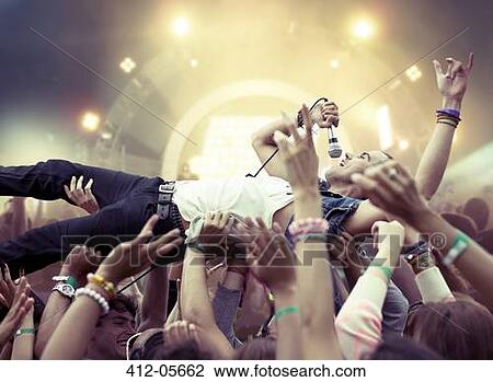 Performer crowd surfing at music festival View Large Photo Image Stock Image - Performer crowd surfing at music festival. Fotosearch