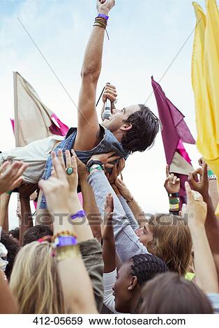 Performer crowd surfing at music festival View Large Photo Image Stock Photo - Performer crowd surfing at music festival. Fotosearch