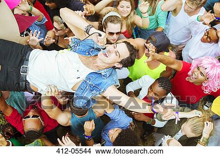 Performer with microphone crowd surfing at music festival View Large Photo Image Picture - Performer with microphone crowd surfing at music festival. Fotosearch