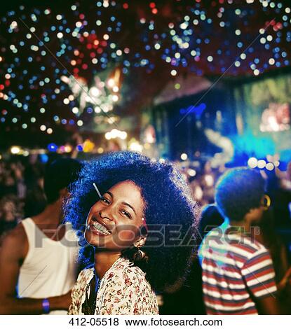 Stock Photo - Portrait of enthusiastic woman at music festival. Fotosearch