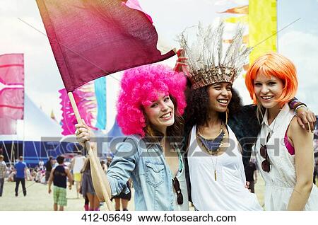 Portrait of friends in wigs at music festival View Large Photo Image Stock Photo - Portrait of friends in wigs at music festival. Fotosearch