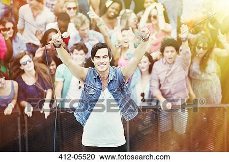 Portrait of performer with fans in background at music festival View Large Photo Image Stock Image - Portrait of performer with fans in background at music festival. Fotosearch